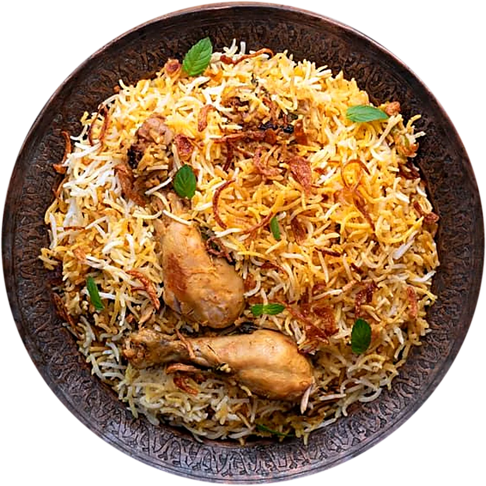 Hyderabadi chicken dum biryani with leg pieces on an engraved copper plate